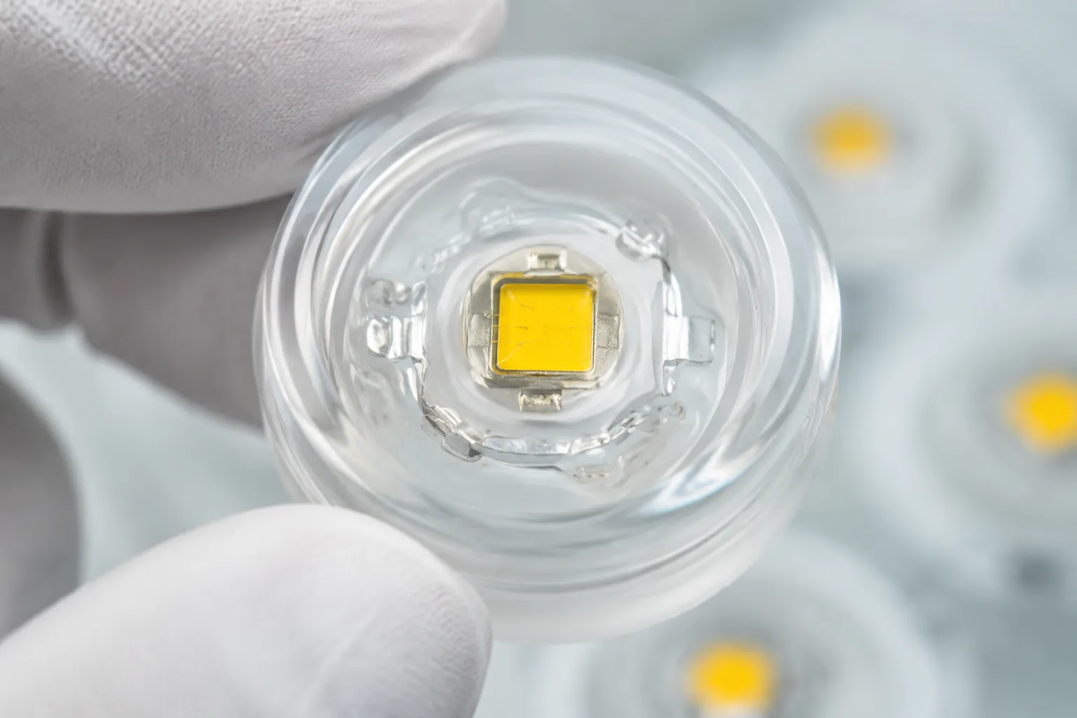 A laboratory setting displays a clear silicone encapsulant covering an LED chip, highlighting its optical clarity and refractive behavior in modern LED packaging.