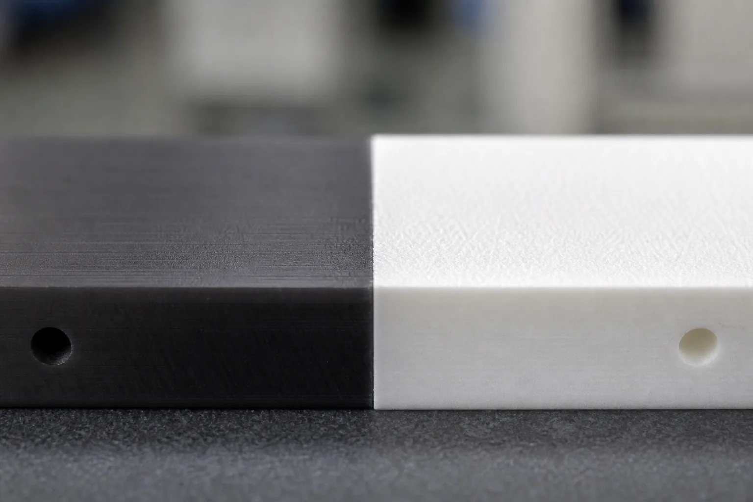 A clean, technical close-up illustrating the contrasting surfaces of POM and PTFE before and after primer application, highlighting the industrial challenge.