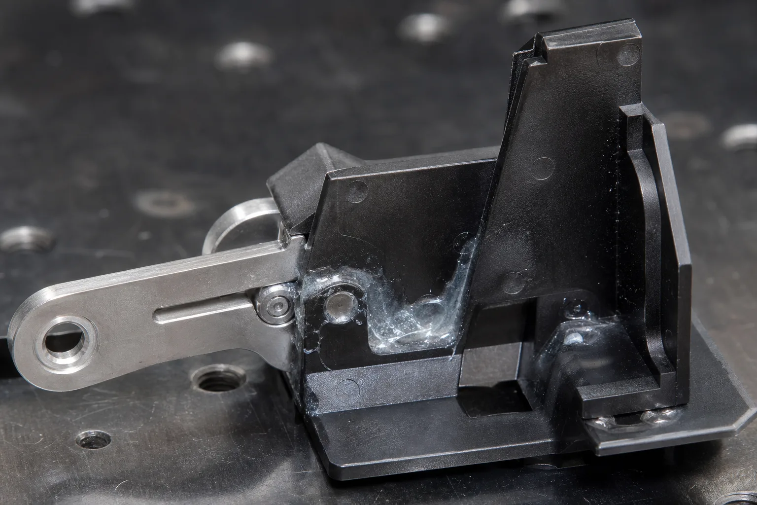 This image illustrates the challenge of removing cured super glue from mixed materials in an industrial environment, reflecting safe debonding practices.